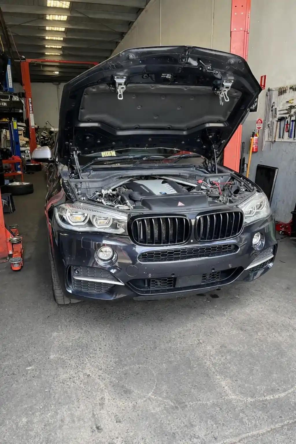 BMW SUV in workshop with open hood_4_11zon_11zon